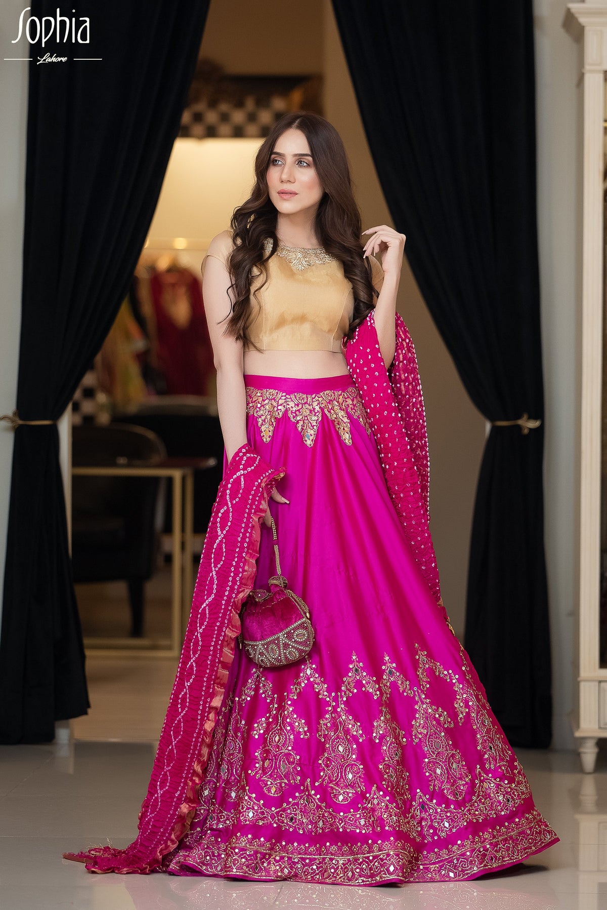 Hot pink lengha in chamois with beautiful block printed pattern fully embellished with glittering details in mirrors and sequins.